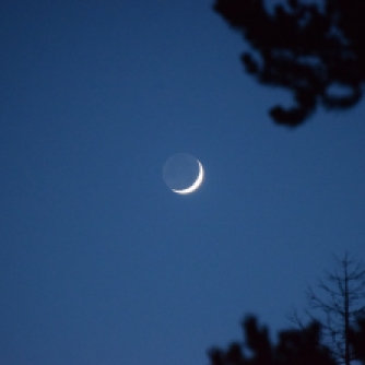 Waxing crescent Moon with earthshine above Abriachan
